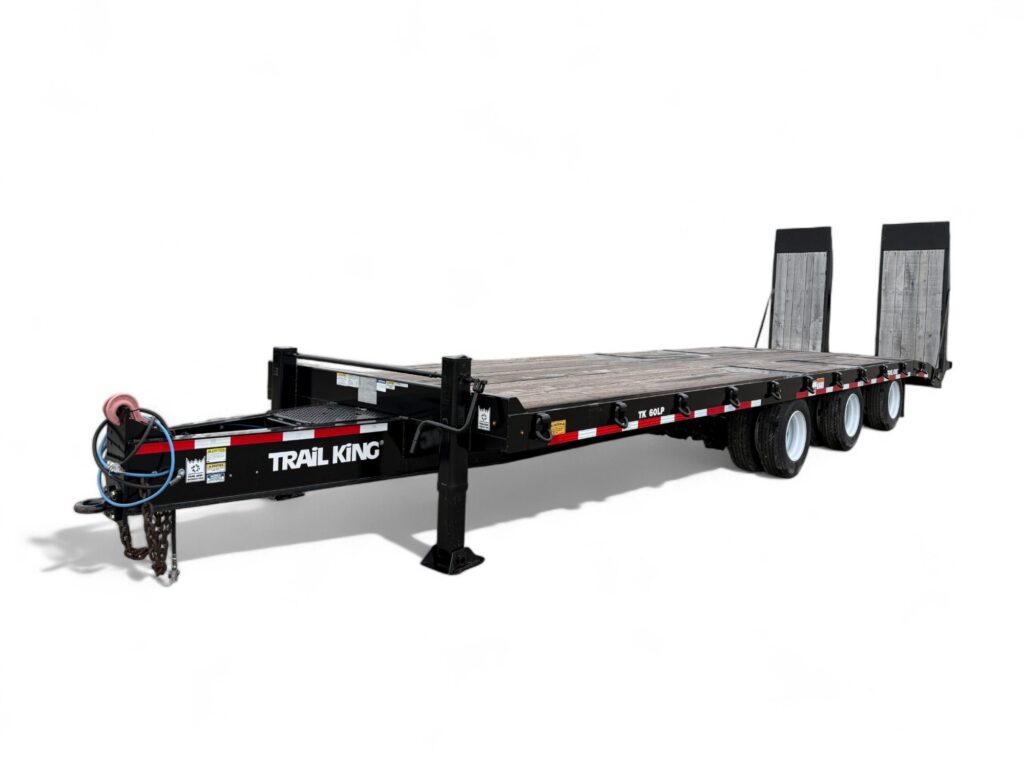 A black, flatbed utility trailer with three axles and two rear loading ramps, labeled "TRAIL KING" on the side, shown on a white background.