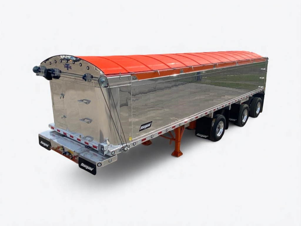 A shiny, silver three-axle dump trailer with an orange tarp covering the top is parked on a white background. The trailer has black tires and orange support legs at the front.